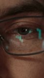Close-up of a male trader eye with candlestick charts and financial graphs reflecting in his eyeglasses, symbolizing intense market analysis and crypto trading. Vertical video - Powered by Shutterstock - Get 15% off with code: PIKWIZARD15