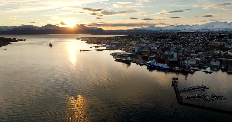 Sunset aerial view early winter over Tromso city with Hurtigruten ship docking