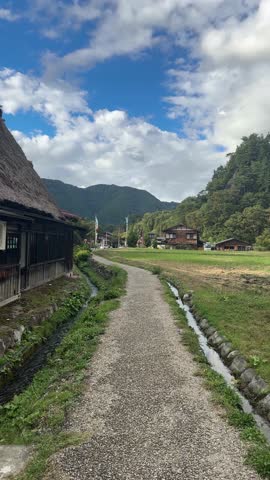 Pov walking on a rural path in Shirakawa go, a UNESCO World Heritage site in Japan