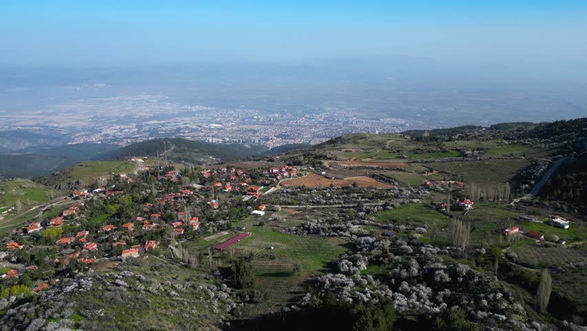 Aerial View of Mountain Village Overlooking Sprawling City