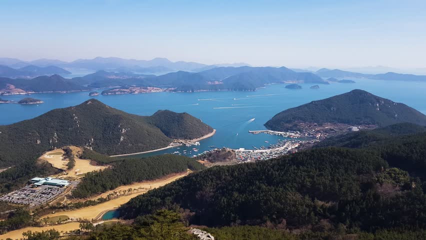 Stunning sweeping view of Korea national marine park showing islands forested hills and seaside town