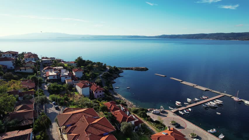 Aerial Coastal Landscape in Greece. Crystal Blue Fishing Bay in Pyrgadikia, Greece. Greek Seaside Village background.