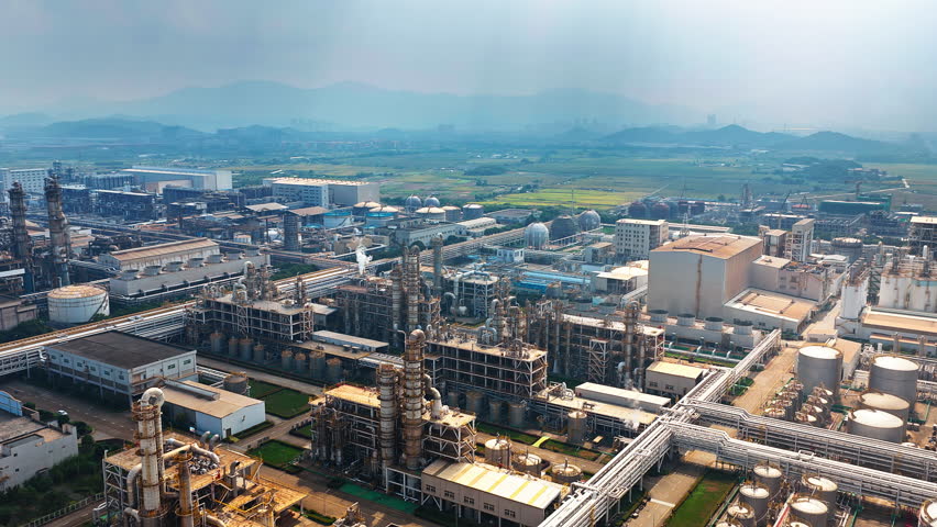 Aerial shot of large chemical plant and pipeline equipment with storage tank in the industrial area