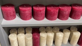 A candle shop with lots of different colorful craft candles box with white ribbon, red candles tied with ribbon, empty tag on wood - Powered by Shutterstock - Get 15% off with code: PIKWIZARD15