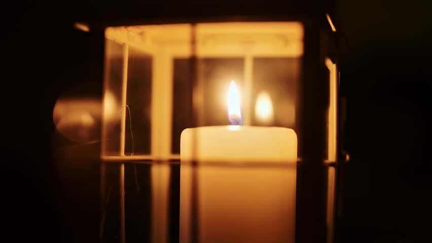 Low light shot of flame flickering and dying in calm indoor evening ambiance