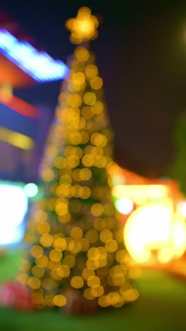 out of focus Christmas tree at night at vertical composition