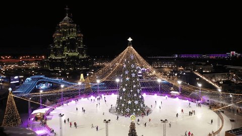 Drone Circling above Illuminated Christmas Tree Rink