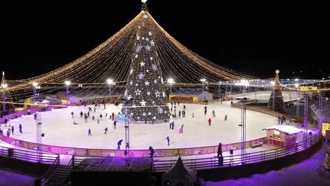 Overhead Drone Ascent Revealing Bright Winter Skating