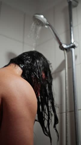Man Cleans Hair In Shower, Male Musician Rinses Grime From Hair, Man Washes Long Hair Under Steady Shower Stream, Male Artist Carefully Cleans His Lengthy Hair During Intimate Shower Routine