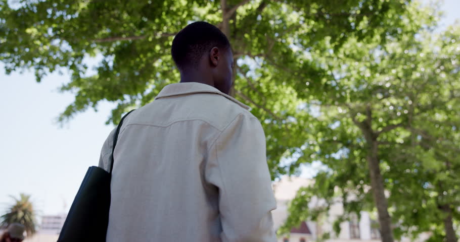 Back, student and black man in city, below and walking with urban town, scholarship or university. Travel, commute or African person with higher education, college or pedestrian with gen z or explore
