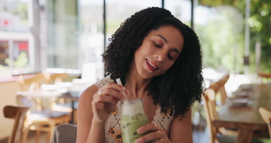 Smile, woman and relax with drink at cafe with iced matcha latte, refreshing smoothie and mix flavor. Happy, female person and green milkshake for healthy beverage, nutrition benefits and weight loss