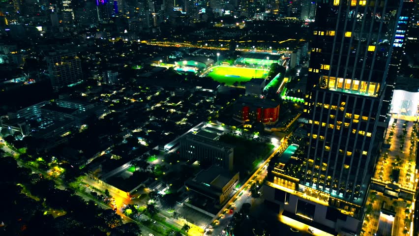 aerial drone view of night Bangkok city skyline with modern high-rise skyscrapers and illuminated streets, financial downtown district top view, street lights of futuristic capital of Thailand 4k