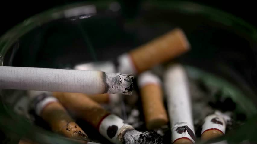 closeup tobacco addiction cigarette in ashtray narcotic addict nicotine cancer risk illustration