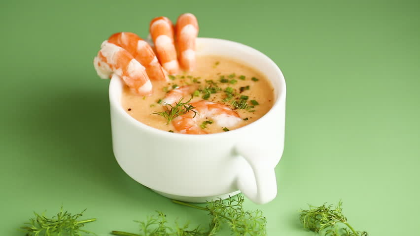 Hot savory shrimp chowder with dill and chives in elegant ceramic cup