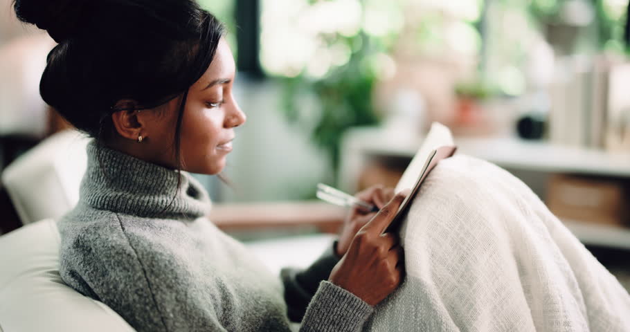 Diary, thinking and writing with woman on sofa in living room of home for reflection or memories. Journaling, notebook and pen with thoughtful person in apartment for personal growth or planning
