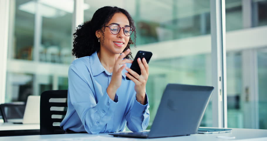 Woman, phone and happy with texting at office, glasses and laptop for web consulting at insurance agency. Person, broker or advisor with smartphone, smile and mobile app at risk management company