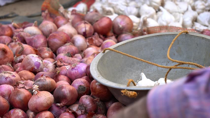 Red onions and garlic selling in a indian market.