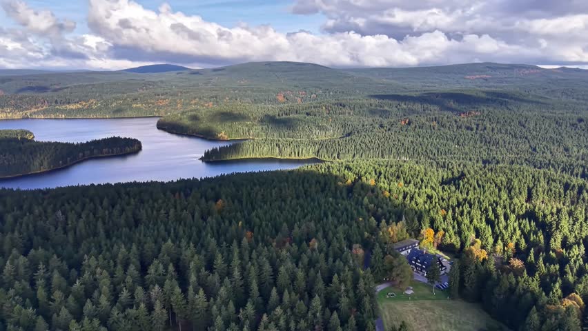 Aerial Lake Panorama Showing Dense Conifer Forest Islands And Reflective Water, Drone Survey For Conservation