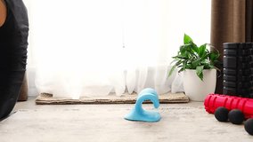 Young woman lies on the floor using a blue cervical traction device to stretch the neck. Home therapy for neck pain, muscle tension and spine decompression - Powered by Shutterstock - Get 15% off with code: PIKWIZARD15