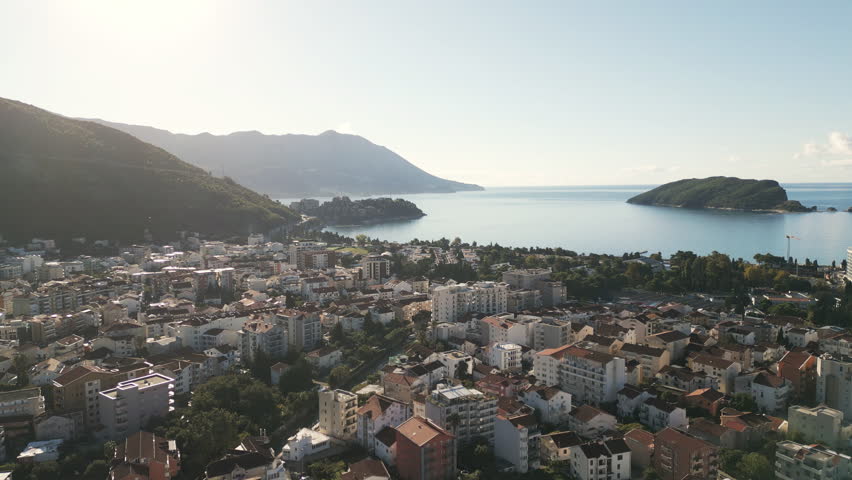 Aerial video of a scenic panorama of Budva, a vibrant coastal city nestled on the Adriatic shore in southern Montenegro.