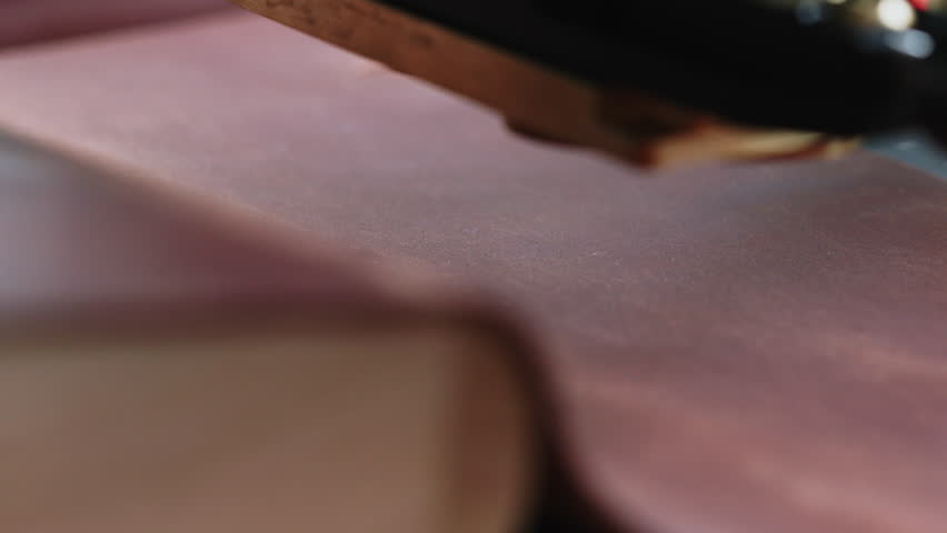 Macro hot stamping logo on brown leather close up embossing process for handmade wallet or luxury branding