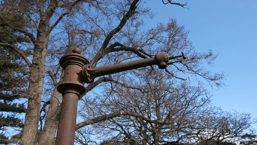 Old rusted Victorian-era garden sprinkler or water cannon in Werribee Park, Australia. Concept of historic public infrastructure, abandoned utility, heritage, and industrial relic