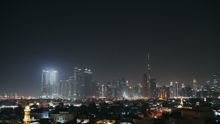 Fantastic nighttime panorama of Dubai skyline showing its downtown illuminated skyscrapers including the iconic Burj Khalifa