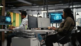 Multiethnic technicians in startup office work with artificial intelligence driving market innovation. Teamworking tech agency colleagues apply machine learning to optimize operations, camera A - Powered by Shutterstock - Get 15% off with code: PIKWIZARD15