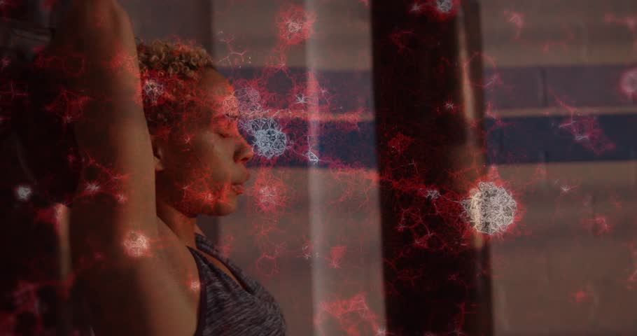 Gym athlete doing overhead move, on inhale, pushing bag up for strength, red overlay showing motion. Woman, weight, deltoids, focus, fitness, training, repetition