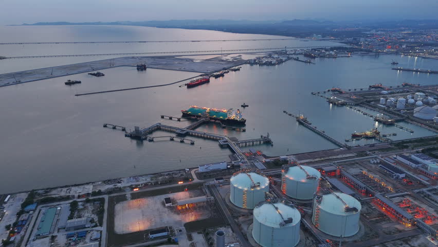 LNG (Liquified Natural Gas) tanker anchored in Gas terminal gas tanks for storage. Oil Crude Gas Tanker Ship. LPG at Tanker Bay Petroleum Chemical or Methane freighter export import transportation