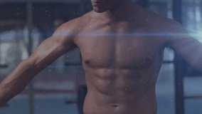 Fitness model rotating torso, holding pose in gym, camera shift overlaying flares and dust for ad. Athletic, muscular, rotation, stance, flare, particles, studio - Powered by Shutterstock - Get 15% off with code: PIKWIZARD15