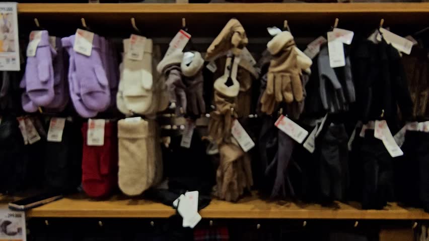 Display colorful winter gloves or winter mittens and socks in departmen store.Blurr