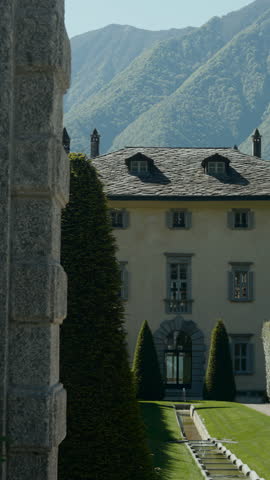 Elegant villa in the italian alps surrounded by green gardens. Action