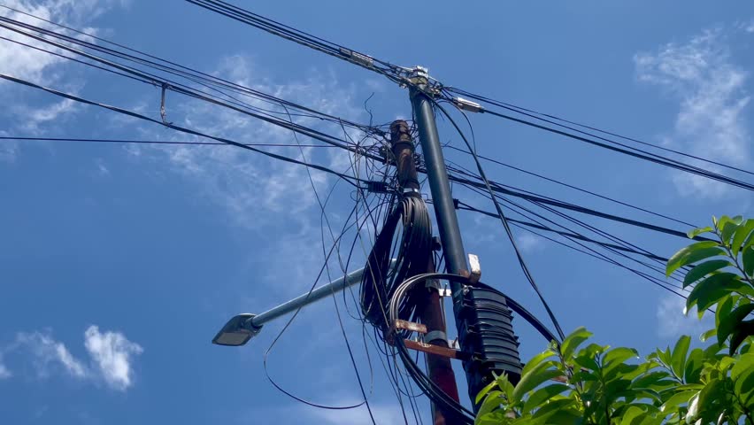 close-up view of an electric pole with a blue sky background
