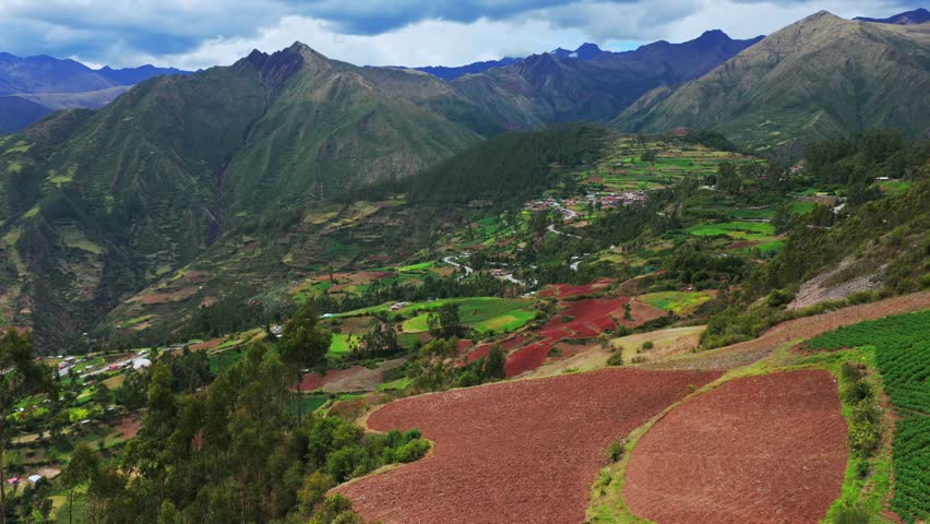Peruvian Andes mountain range Limatambo Heertahuayco valley highlands avocado farm crops mount Humantay Salkantay Peru aerial drone Cusco region warm climate Soray rainy season clouds forward pan up