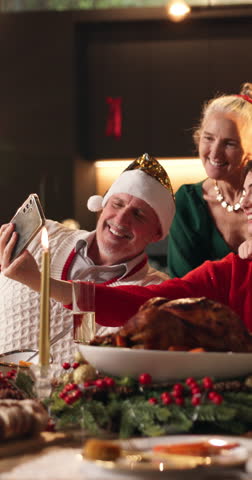 Christmas, dinner and happy family in home with selfie for memories, bonding or holiday tradition. People, smile and photography in house for festive party, social media xmas post or supper together.