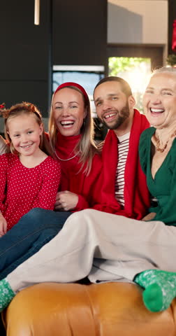 Face, big family and happy in home on Christmas for celebration, festive season or bonding together. Grandparents, people and kid with hug on sofa for xmas reunion, support and generations in house