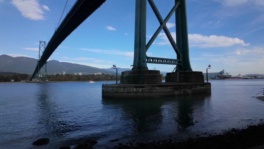 Gimbal close tilting-up shot of the Lions Gate Bridge pylon during sunny weather in Vancouver, British Columbia, Canada. 4K