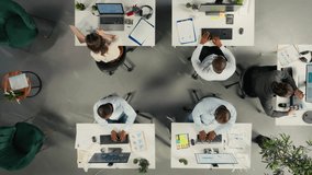 Business team uses artificial intelligence tech to automate data entry tasks, digital ecosystem HUD overlay. Top down view of company workers streamlining workflow using AI machine learning operations - Powered by Shutterstock - Get 15% off with code: PIKWIZARD15
