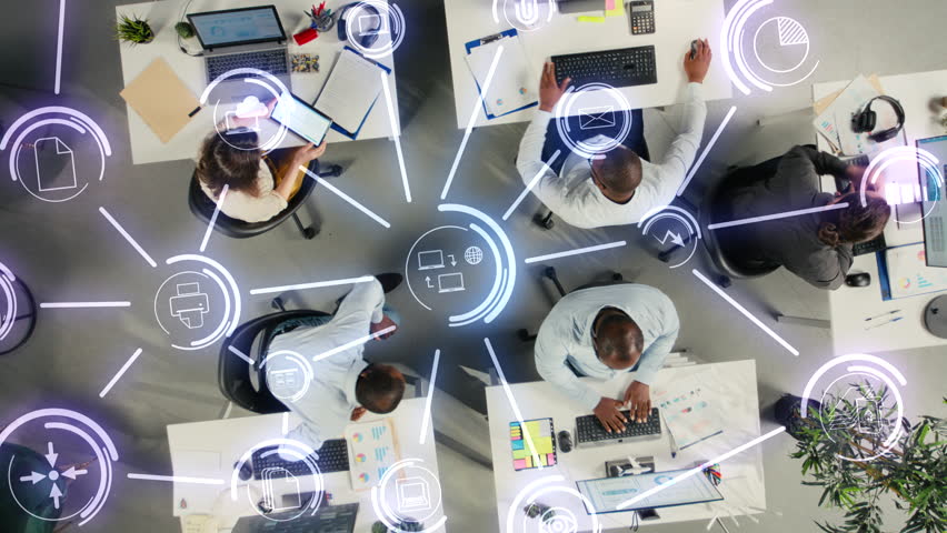 Collaborative team in company office sharing project files via cloud integration, digital ecosystem HUD icons. Aerial view of business colleagues syncing documents via online network on remote server