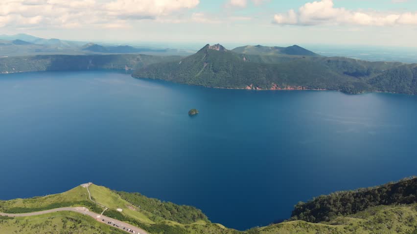 Aerial fly Lake Mashu Caldera in Japan Hokkaido Volcanic Lake, Misty Mountains, slow motion long exposure, Nature