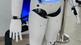 Robotic prototype with white panels blue glow and articulated hands demonstrates future automation in science exhibit - Powered by Shutterstock - Get 15% off with code: PIKWIZARD15