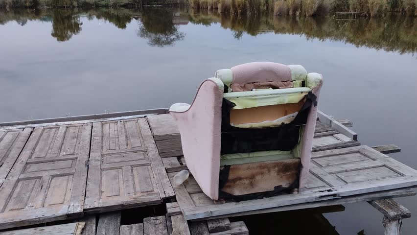 Chair on a pier on a lake in evening
