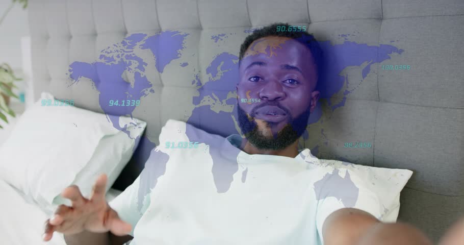 Man reaching toward camera and explaining tech trends, pointing while world map arcs overlaying him. Bedroom, relaxed, handheld, globe, data, analytics, communication