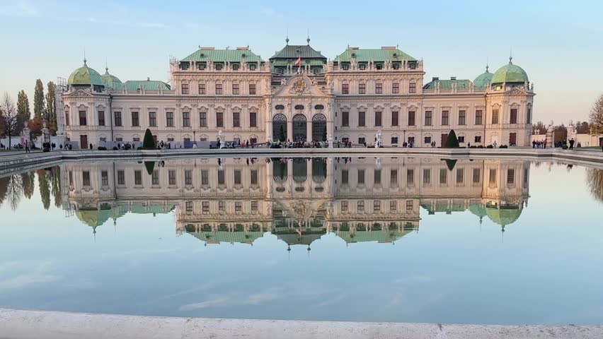 Baroque palace Upper Belvedere with pond on a foreground in historic park-palace complex of the 18th century in autumn evening, Vienna, Austria, view close-up
