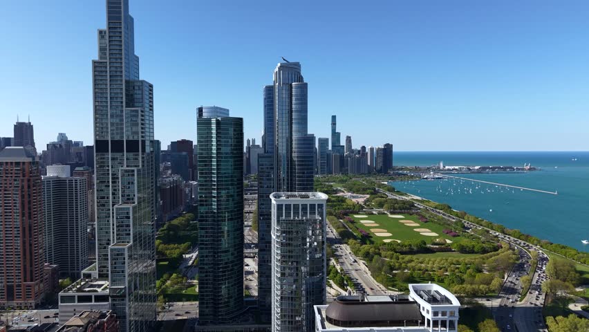 Chicago Cityscape Skyline, Revealing Drone Shot of Grant and Millennium Park by Lake Michigan From Condominium Complex