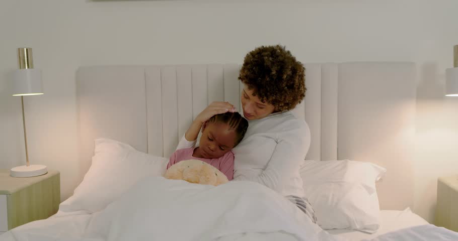 Adult woman soothing child on bed after child leaning in, scanline crossing frame showing health. Caregiver, kid, plush, comfort, cozy, intimate, home