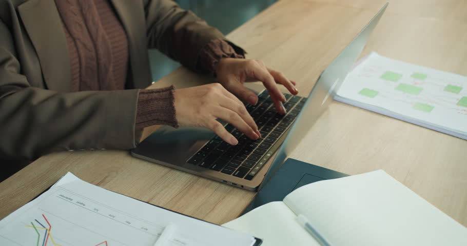 Individual meticulously entering information into digital spreadsheet