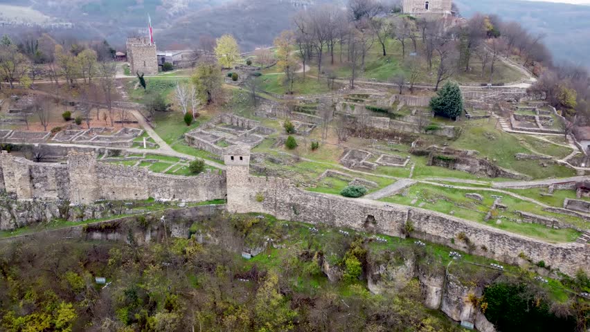 Tsarevets Fortress in Veliko Tarnovo, Bulgaria, with medieval stone walls and hillside ruins set above the surrounding landscape.