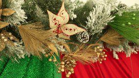 Captivating close-up of Christmas decorations with frosted pine cones, vibrant red fabric, and festive foliage. This shot captures intricate details under soft, warm lighting. - Powered by Shutterstock - Get 15% off with code: PIKWIZARD15